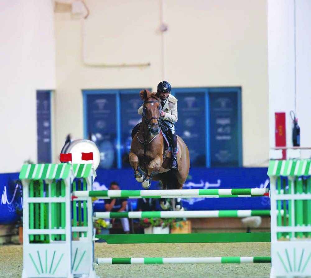 
Salmeen Sultan al-Suwaidi clears a hurdle with Fiori LS en route to his Big Tour class win at the third round of Longines Hathab – Qatar Equestrian Tour yesterday. 
 