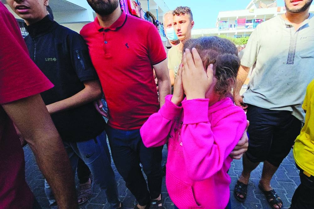 
A Palestinian child reacts following a strike at a UN-run school sheltering displaced people, in the Jabalia refugee camp in the northern Gaza Strip, yesterday. 