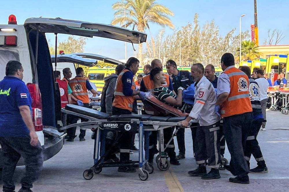 Egyptian paramedics transfer on a gurney an injured Palestinian man on the Egyptian side of the Rafah border crossing with the Gaza Strip in the northeastern North Sinai province on Monday. AFP