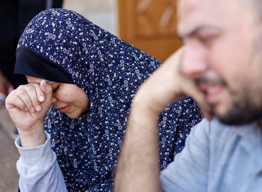 Palestinians react following Israeli strikes, at Nasser hospital, in Khan Younis in the southern Gaza Strip, on Tuesday. REUTERS