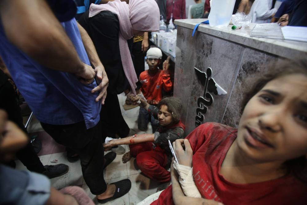 Injured children await treatment at the emergency ward of the Al-Shifa hospital following an Israeli strike, in Gaza City on Sunday. AFP