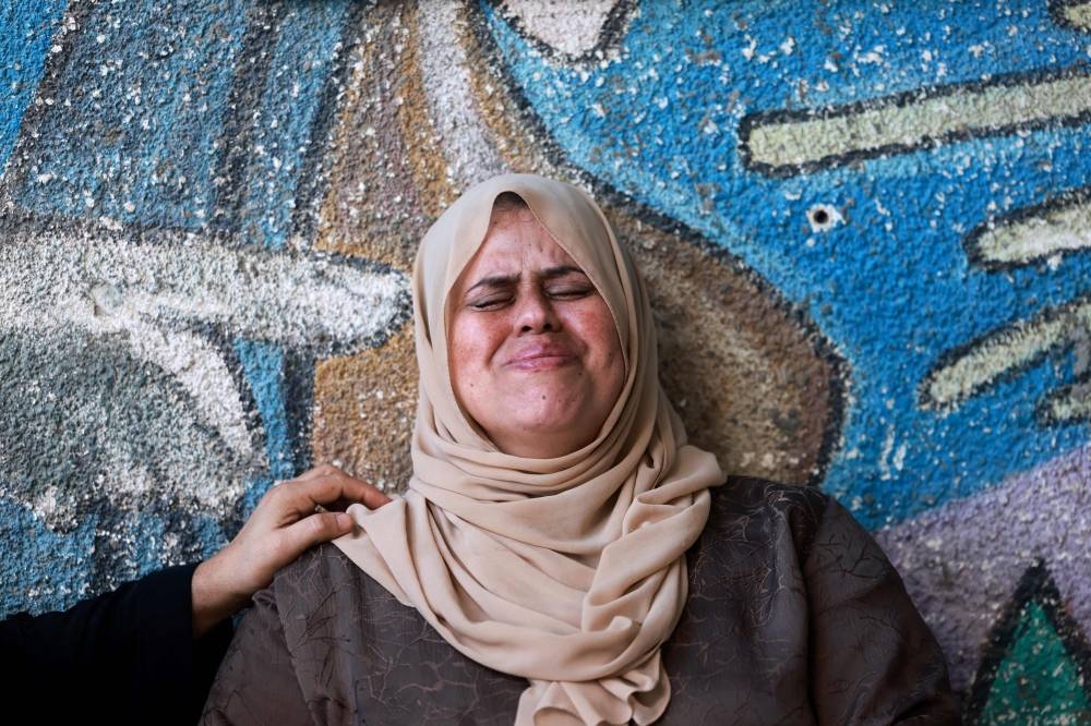 A Palestinian woman cries following an Israeli bombardment in Rafah in the southern Gaza Strip on Tuesday. AFP