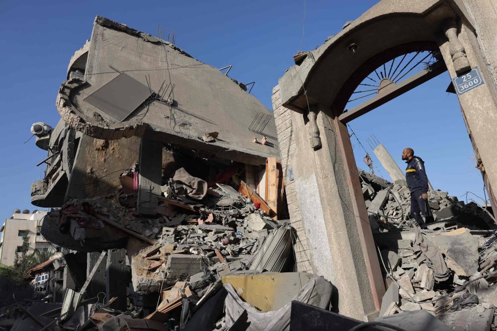 A Palestinian man checks a destroyed house after an Israeli bombardment in Rafah in the southern Gaza Strip on Tuesday, amid continuing battles between Israel and Hamas. AFP