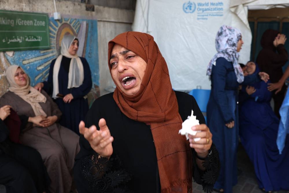 A Palestinian woman cries following an Israeli bombardment in Rafah in the southern Gaza Strip on Tuesday. AFP