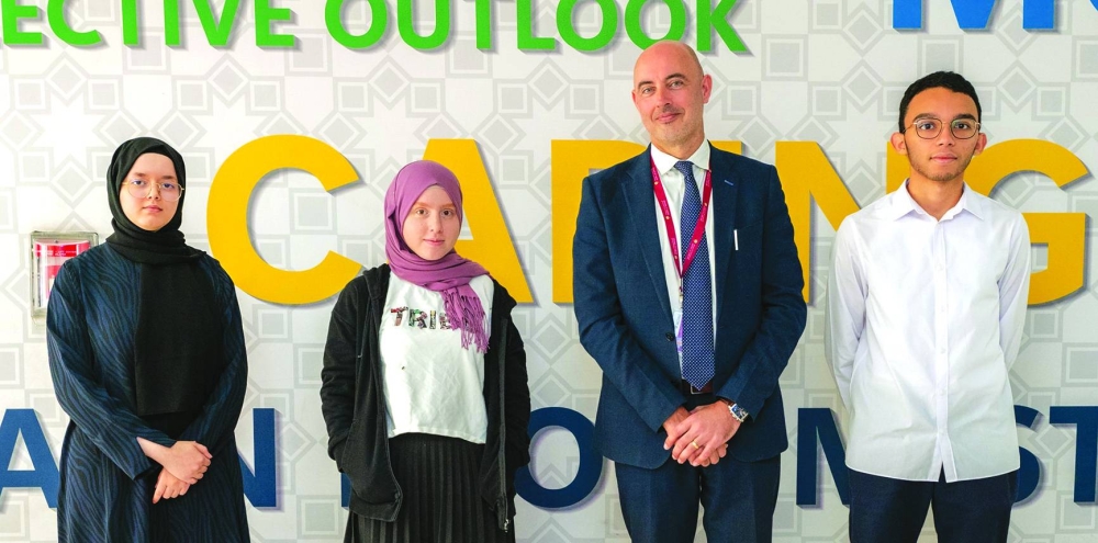 Abdelrahman Hazem Ahmed Fouad Moustafa, Nour Houssam Baba and Sarah Bouhssine with Doha Academy principal Edward Cooper.