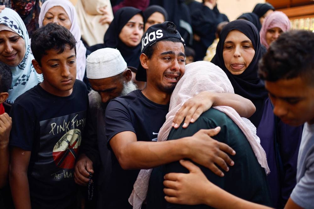 People mourn Palestinians killed in Israeli strikes at a hospital in Khan Younis in the southern Gaza Strip, Wednesday. REUTERS