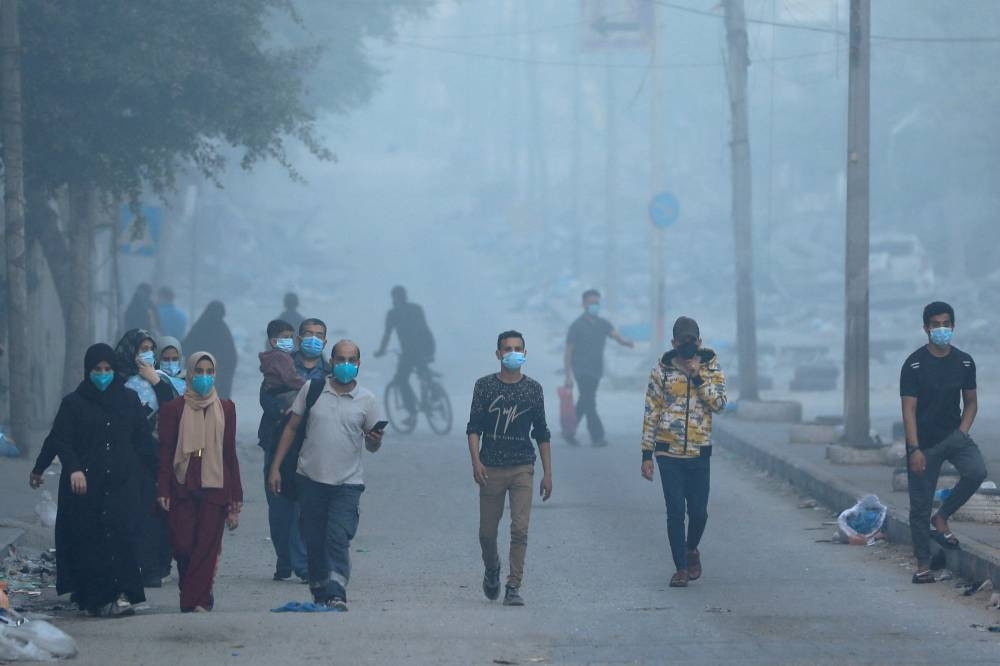 Palestinians flee their homes during Israel's ground offensive, on the edges of Beach refugee camp, in Gaza City, Wednesday. REUTERS