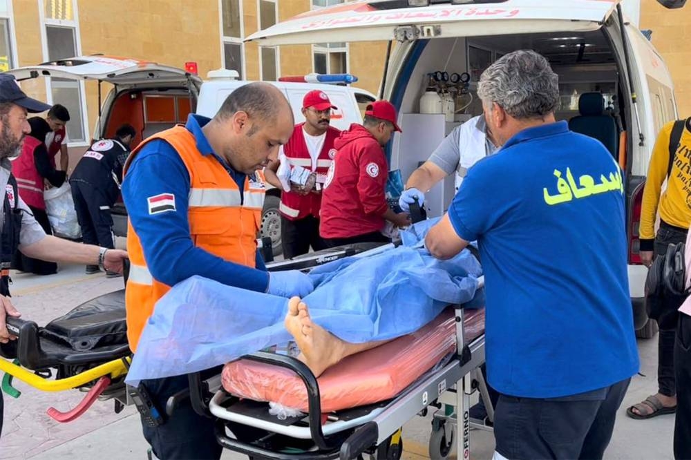 Egyptian medical staff transfer Palestinian wounded at the Egyptian side of the Rafah border crossing between the Gaza Strip and Egypt, on Friday. AFP