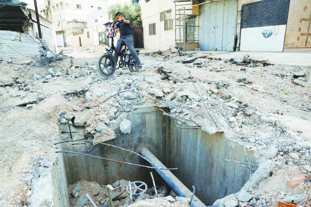 
A Palestinian boy checks damage after Israeli forces raided Jenin 
refugee camp in the occupied West Bank, yesterday. 