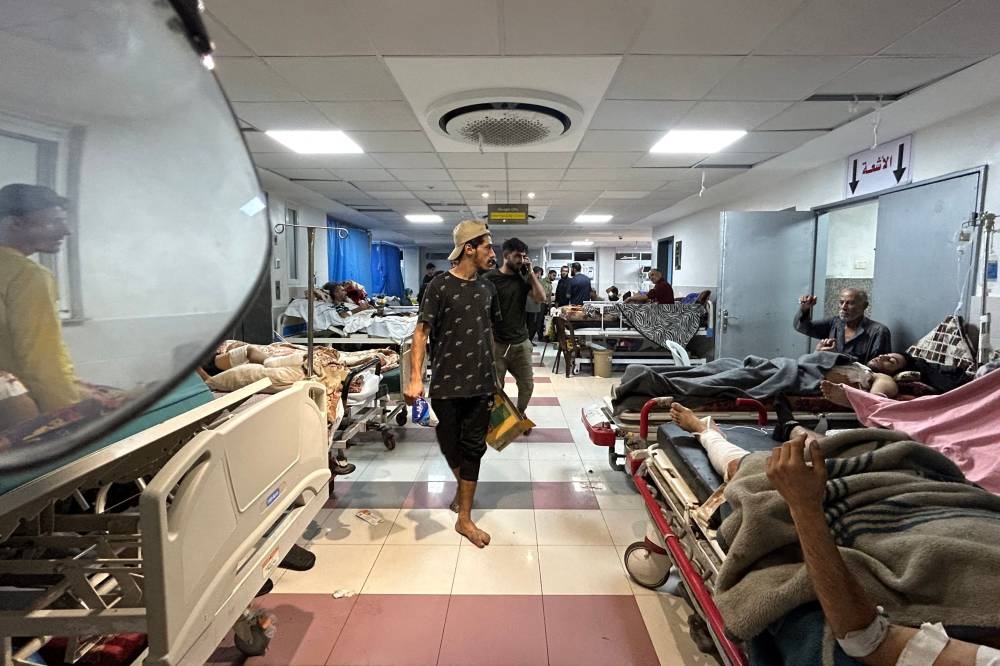 Men walk as patients rest at Al-Shifa hospital in Gaza City on November on Friday. AFP