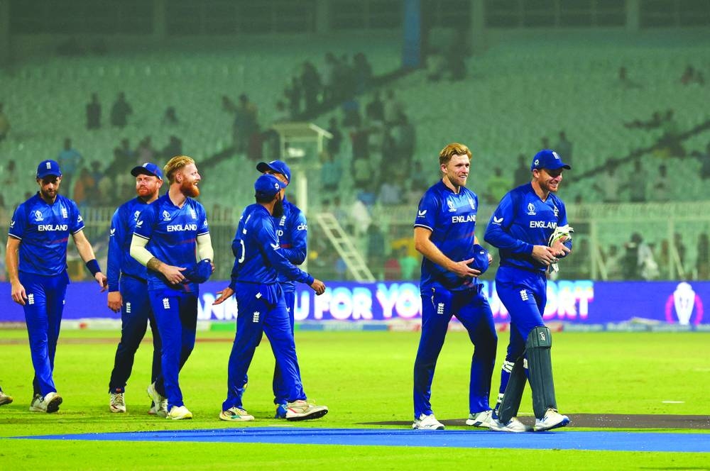 David Willey (second right) with captain Jos Buttler (right) and teammates after playing his last international for England during their ICC World Cup match against Pakistan in Kolkata yesterday. (Reuters)