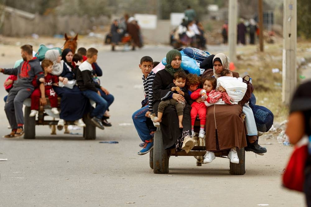 Palestinians flee north Gaza to move southward, as Israeli tanks roll deeper into the enclave, in the central Gaza Strip, on Sunday. REUTERS