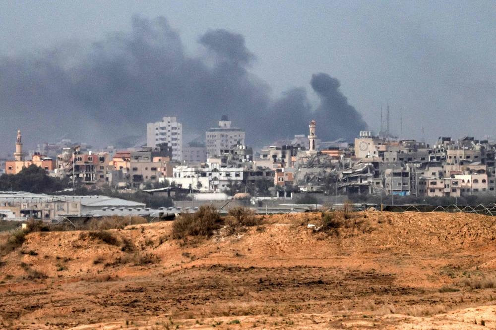 Smoke plumes billow during Israeli bombardment in the northern Gaza Strip from a position near the border with southern Israel on Sunday. AFP