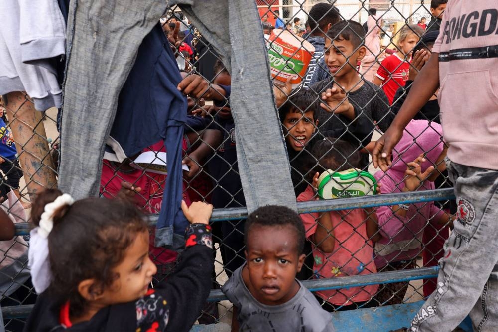 Displaced Palestinian children gather for breakfast at a refugee camp in Rafah in the southern Gaza Strip, on Sunday. AFP