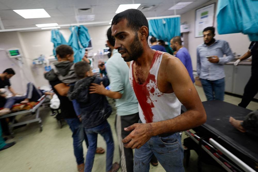 A Palestinian man, wounded in an Israeli strike, is rushed into Nasser hospital, amid the ongoing conflict between Israel and the Palestinian group Hamas, in Khan Younis in the southern Gaza Strip, on Monday. REUTERS