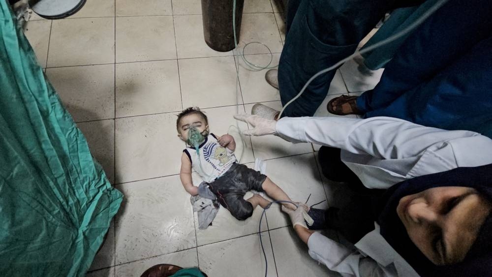 Medical workers try to rescue Palestinian baby Mosab Sobieh, who is less than a year old and was injured in an Israeli strike on their home, at the Indonesian Hospital that ran out of fuel and electricity, in the northern Gaza Strip, on Monday. REUTERS