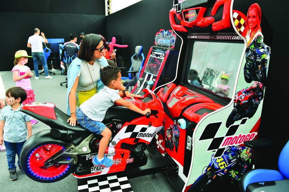 A young fan enjoys a bike ride at the Fanzone.