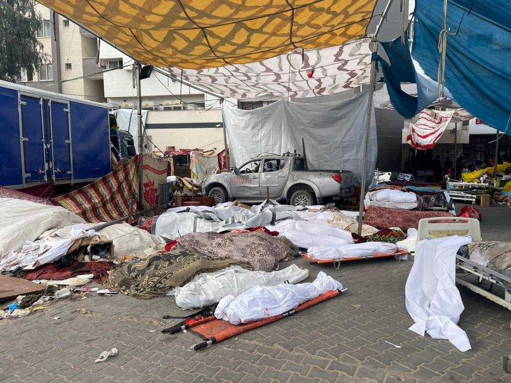 Bodies of Palestinians killed in Israeli strikes lie on the ground at the yard of Al Shifa hospital as health officials say they are unable to bury them due to the Israeli ground operation around the hospital, on November 12. Ahmed El Mokhallalati/via REUTERS 