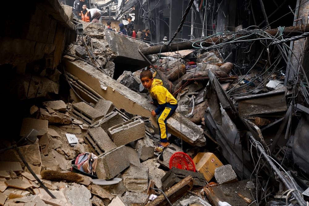 A Palestinian boy looks on at the site of an Israeli strike on a house, in Khan Younis in the southern Gaza Strip Wednesday. REUTERS
