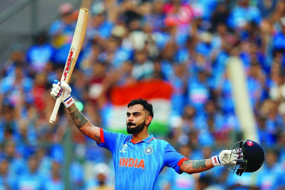 
India’s Virat Kohli acknowledges the crowd and walks back to the pavilion after losing his wicket, caught out by New Zealand’s Devon Conway off the bowling of Tim Southee in the first semi-final of the ICC World Cup in Mumbai yesterday. Right: India’s Mohamed Shami celebrates with teammates after taking the wicket of New Zealand’s Tom Latham in Mumbai yesterday. (Reuters) 