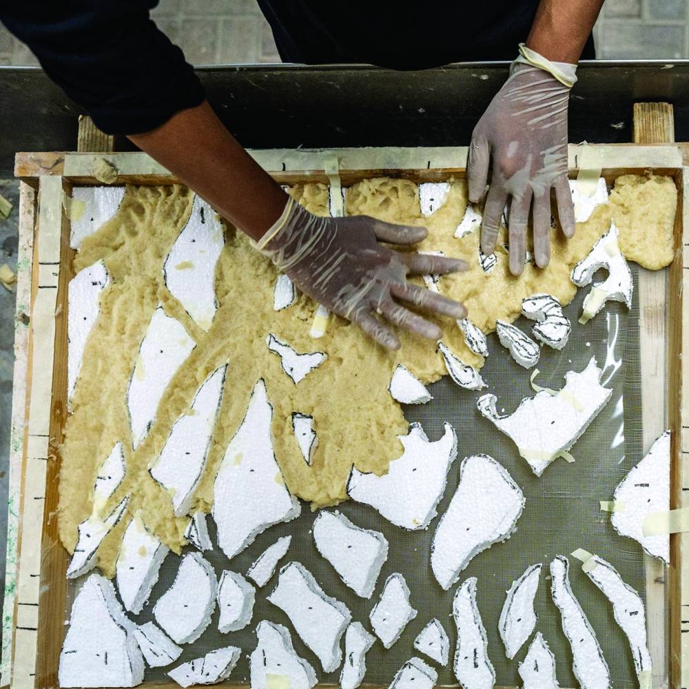 Widi making paper pulp art.