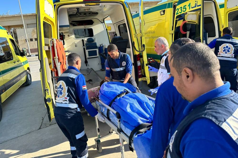 Egyptian paramedics transfer an injured Palestinian to an ambulance after being transported from the Gaza Strip via the Rafah border crossing, on Friday. AFP