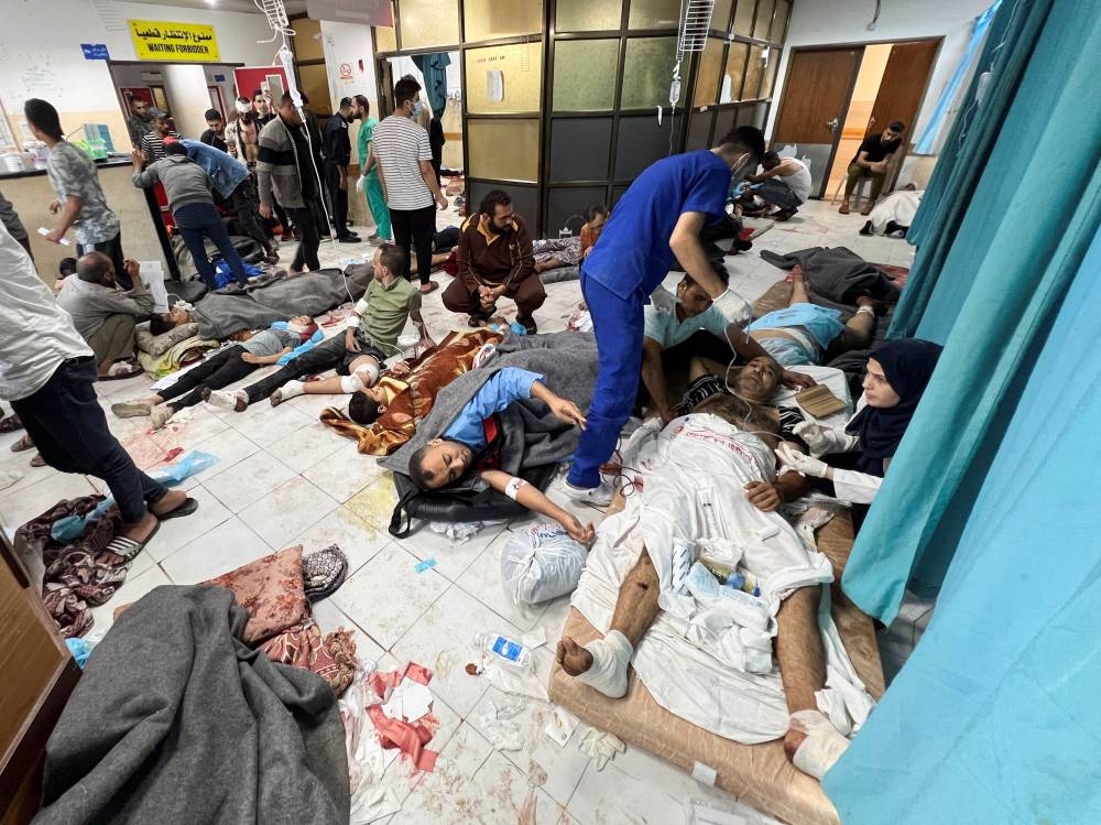 Palestinians wounded in Israeli strikes lie on the floor as they are assisted at the Indonesian hospital after Al Shifa hospital has gone out of service amid Israeli ground offensive, in the northern Gaza Strip Thursday. REUTERS