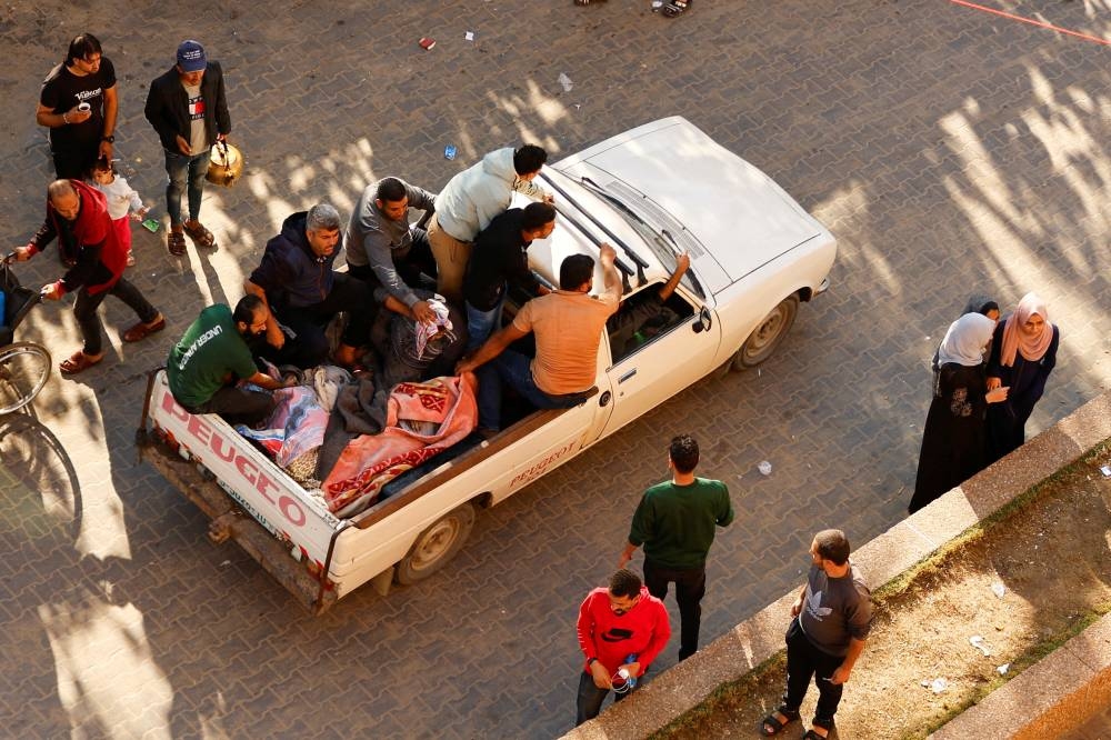 A vehicle carries bodies of seven Palestinian casualties, following an Israeli strike in Khan Younis in the southern Gaza Strip, on Friday. REUTERS