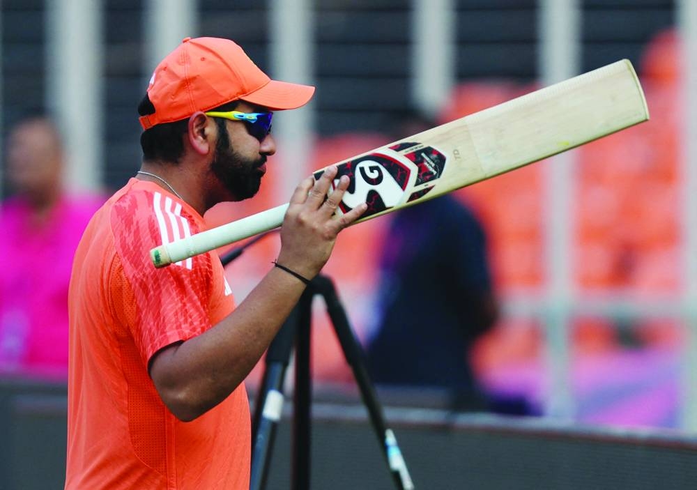 India’s Rohit Sharma during practice in Ahmedabad ahead of the ICC World Cup final against Australia. Right: Australia’s captain Pat Cummins celebrates his team’s win at the end of the ICC World Cup semi-final against South Africa at the Eden Gardens in Kolkata on Thursday. (Reuters/AFP)