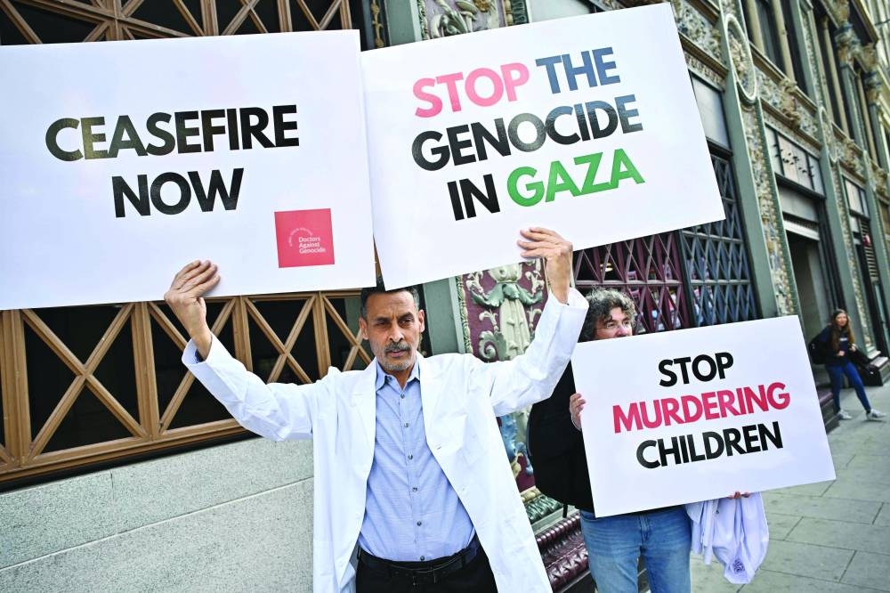 
Demonstrators in support of Palestinians carry signs during a protest to call for a ceasefire, in Washington, DC, yesterday. 