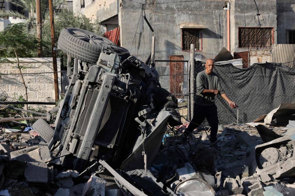 A Palestinian man inspects the debris of a house following an Israeli strike in Rafah in the southern Gaza Strip, on Saturday. AFP