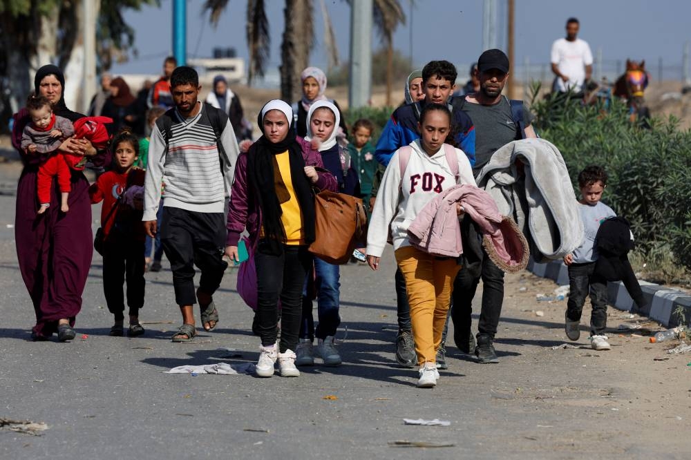 Palestinians fleeing north Gaza move southward, as Israeli tanks roll deeper into the enclave in the central Gaza Strip, on Saturday. REUTERS