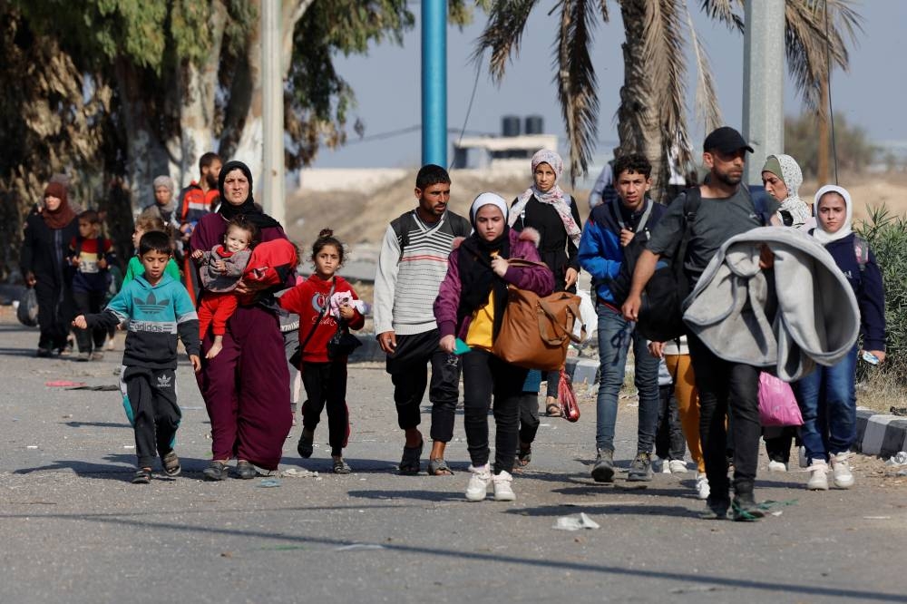 Palestinians fleeing north Gaza move southward, as Israeli tanks roll deeper into the enclave in the central Gaza Strip, on Saturday. REUTERS