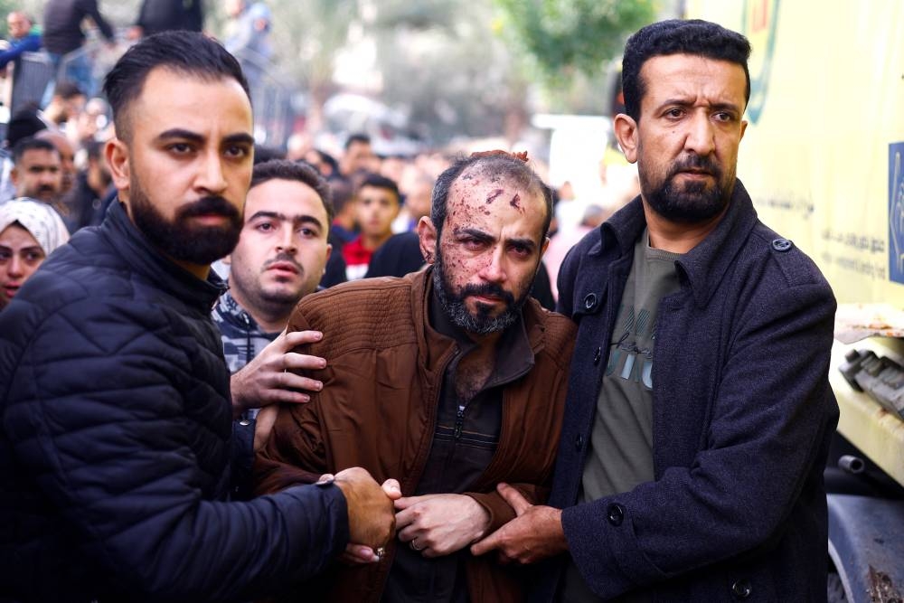 A Palestinian man wounded in an Israeli strike is rushed into Nasser hospita in Khan Younis in the southern Gaza Strip, on Sunday. REUTERS