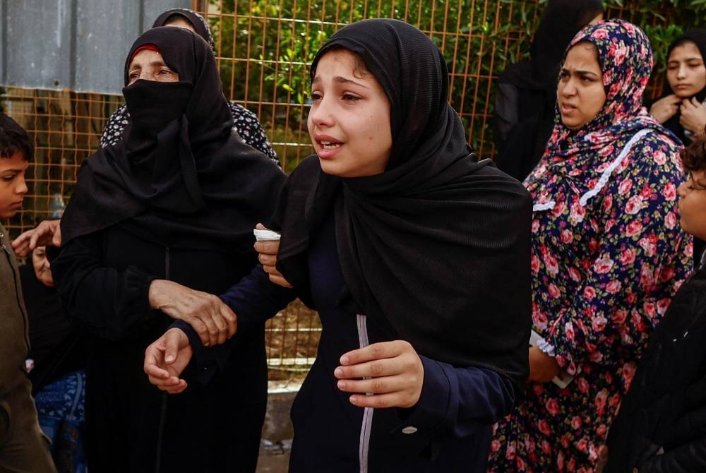 Relatives of Palestinians killed in Israeli strikes mourn at Nasser hospital in Khan Younis in the southern Gaza Strip, on Sunday. REUTERS