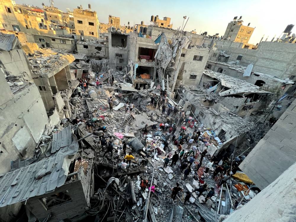 Palestinians search for casualties at the site of Israeli strikes on houses in Jabalia refugee camp, on Saturday. REUTERS