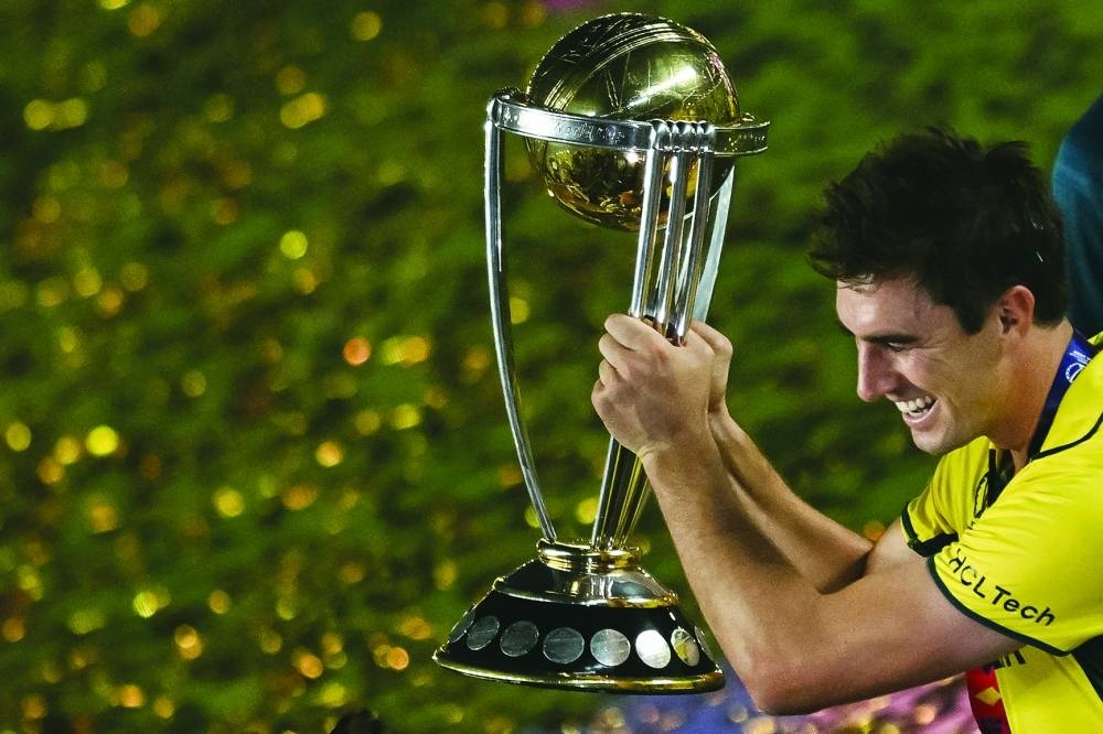Australia's captain Pat Cummins celebrates with the trophy after winning the 2023 ICC Cricket World Cup final against India in Ahmedabad Sunday. AFP