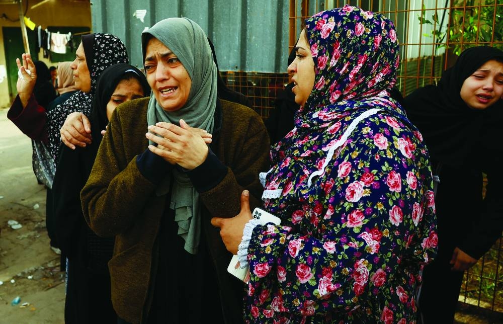 Relatives of Palestinians killed in Israeli strikes mourn at Nasser hospital, in Khan Yunis in the southern Gaza Strip, yesterday.