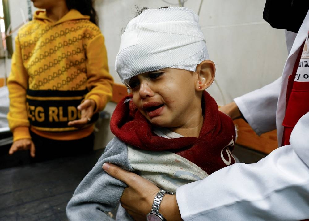 A Palestinian child wounded in an Israeli strike is assisted at Nasser hospital in Khan Younis in the southern Gaza Strip, on Monday. REUTERS
