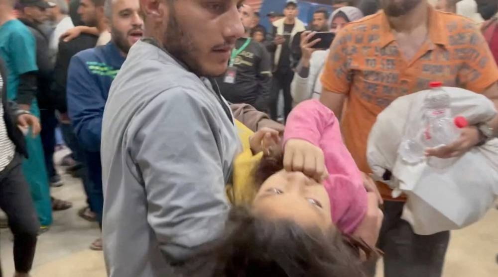 People help an injured Palestinian at Nasser Hospital, amid the ongoing conflict between Israel and Palestinian Islamist group Hamas, in Khan Younis in the southern Gaza Strip on Tuesday. Palestinian Ministry Of Health/Handout via REUTERS 