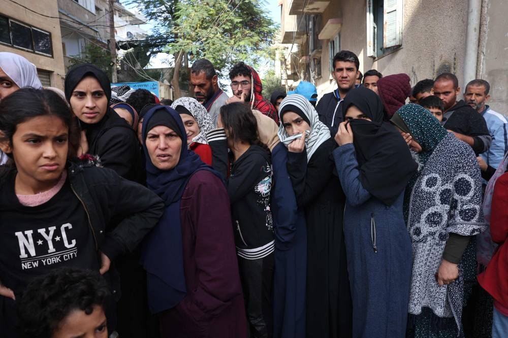Palestinians queue up to buy bread in Khan Yunis in the southern Gaza Strip on, on Tuesday. AFP