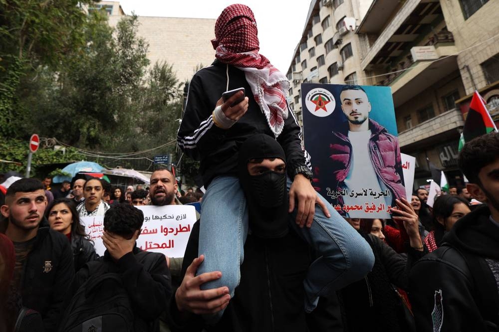 Palestinians march to express their solidarity with the Gaza Strip in the occupied West Bank city of Ramallah on Wednesday. AFP