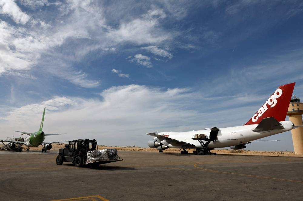 Workers unload humanitarian aid at Egypt's al-Arish Airport on Wednesday, ahead of being transported to the Rafah border area with the Gaza Strip. AFP