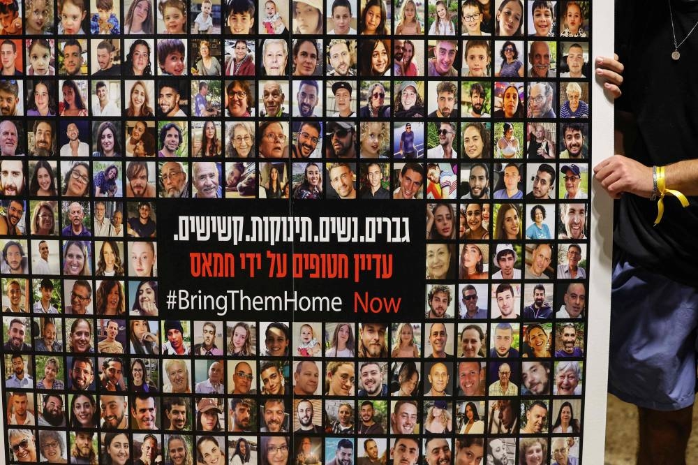 Relatives, friends and supporters of Israeli hostages held in Gaza since the October 7 attack by Hamas in southern Israel, hold placards and images of those taken during a protest for their release in Tel Aviv on Wednesday. AFP