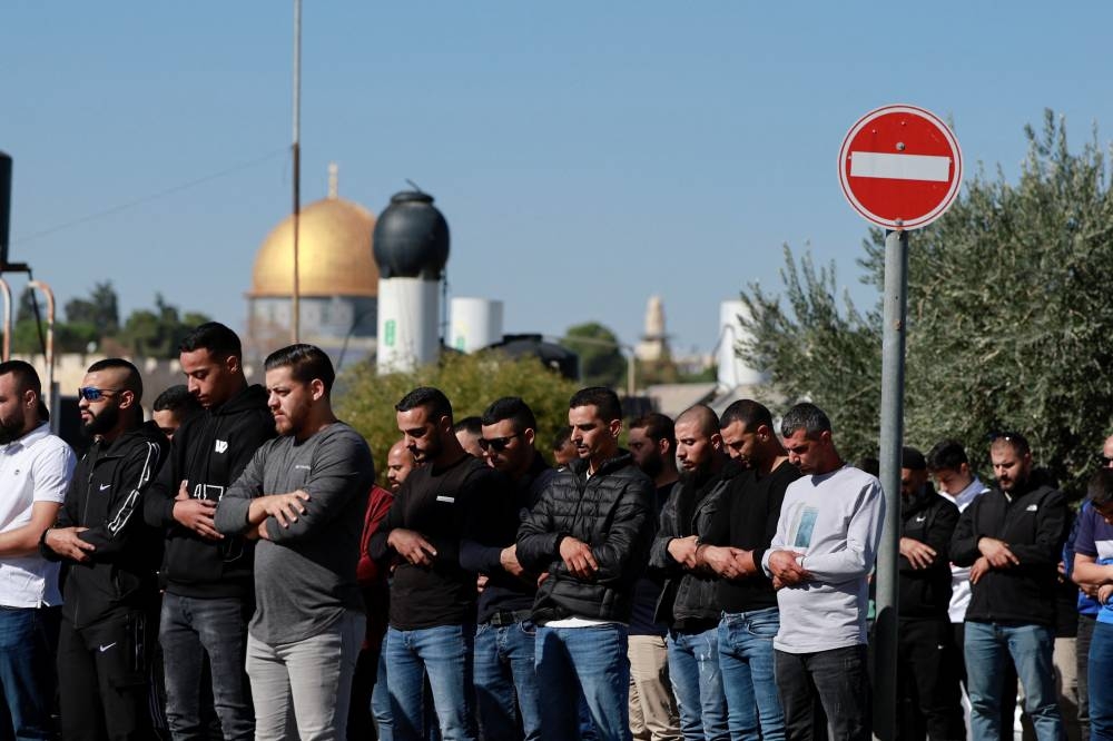 Muslim Palestinians hold Friday prayers, amid a temporary truce in Gaza between Hamas and Israel, in Jerusalem on Friday. REUTERS