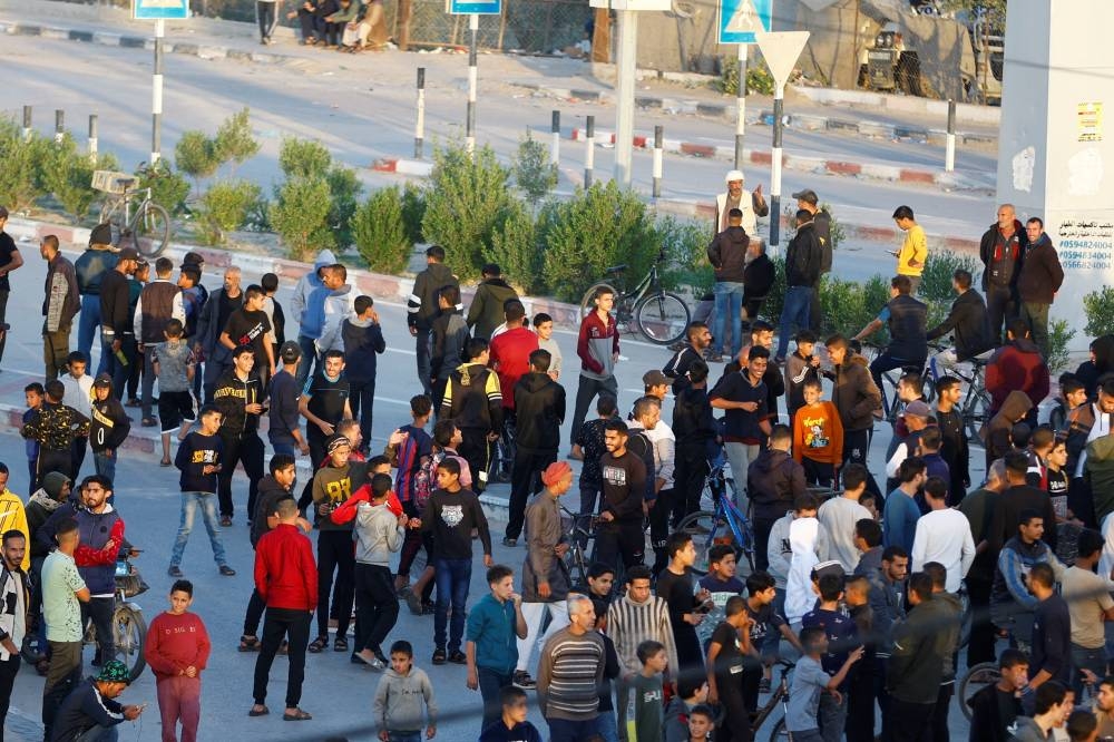 Members of the media and people gather at Rafah border as Hamas militants are expected to release hostages abducted by Hamas during the October 7 attack on Israel as part of a hostages-prisoners swap deal between Hamas and Israel, as seen from southern Gaza Strip Friday. REUTERS