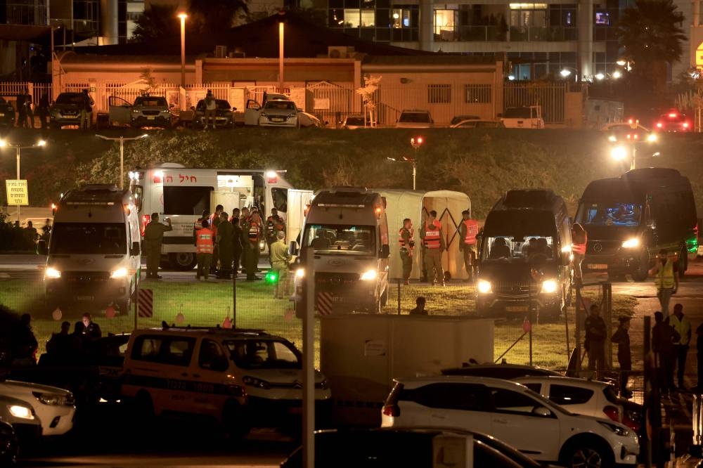 Israeli security forces stand next to ambulances waiting outside the helipad of Tel Aviv's Schneider medical centre on Friday, amid preparations for the release of Israeli hostages held by Hamas in Gaza in exchange for Palestinian prisoners later in the day. AFP