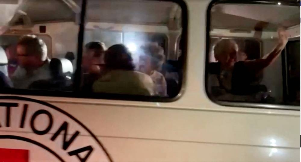 A vehicle carrying hostages arrives at the Rafah border, amid a hostages-prisoners swap deal between Hamas and Israel, from southern Gaza Strip Friday. REUTERS