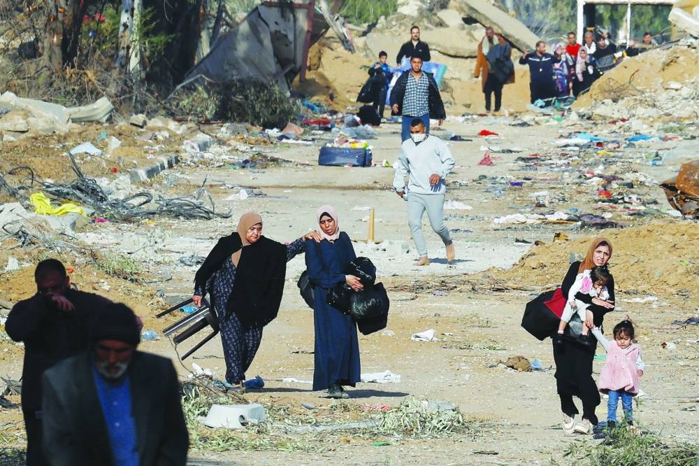 
Palestinians carry their belongings as they flee Gaza City, during a 
temporary truce, near Gaza City, yesterday. 