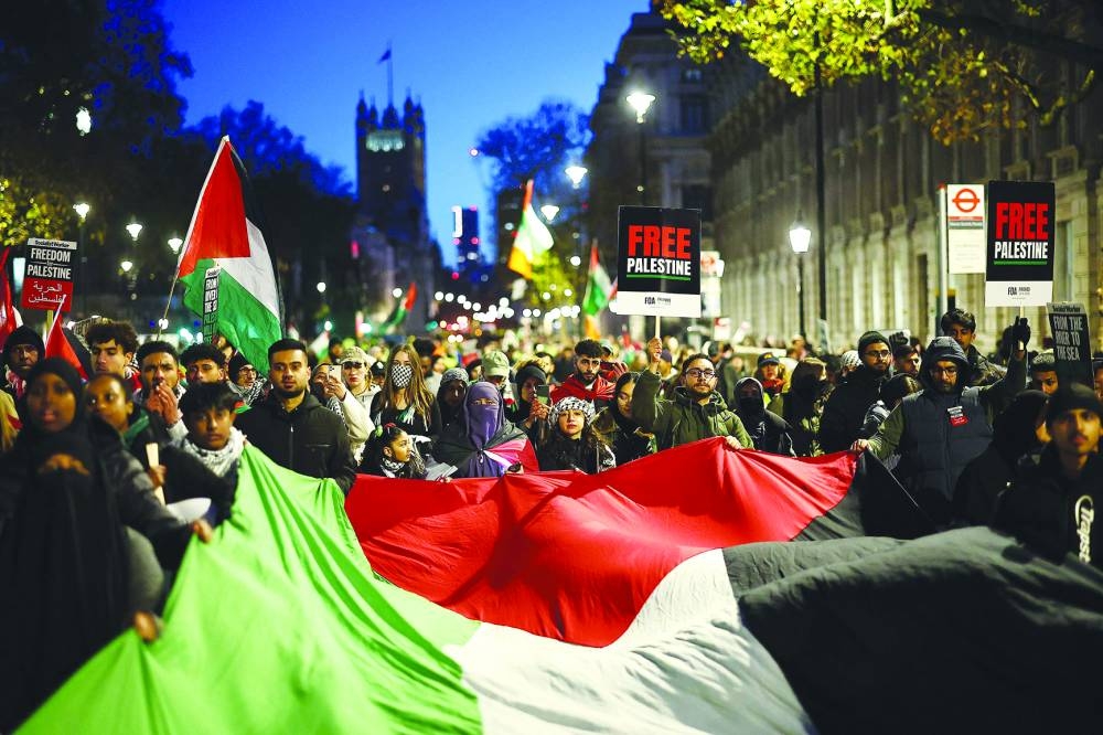 
Protesters waves flags and banners as they take part in a ‘National March For Palestine’ in central London, calling for a ceasefire in the conflict between Israel and Hamas. 